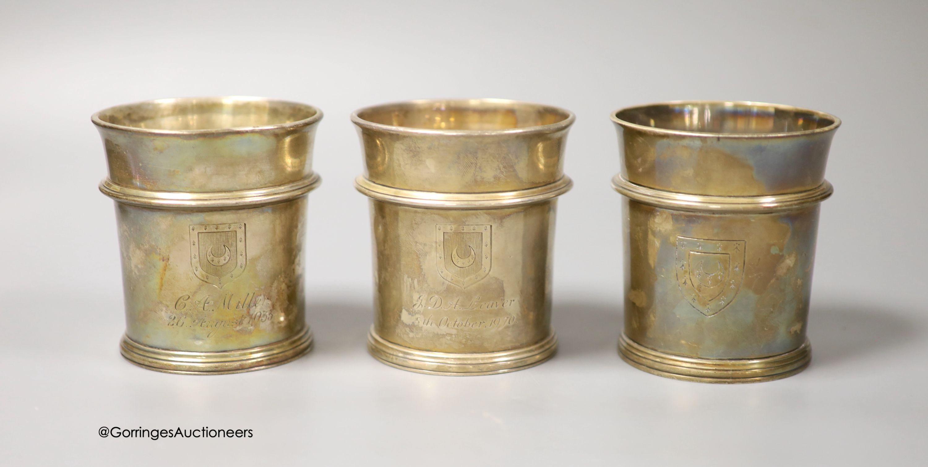 A pair of George V Brittania standard silver beakers, with engraved inscription, W. H. Haseler Ltd, Birmingham, 1933 and one other later similar beaker, How of Edinburgh Ltd, London, 1960, all 94mm, 29.5oz.